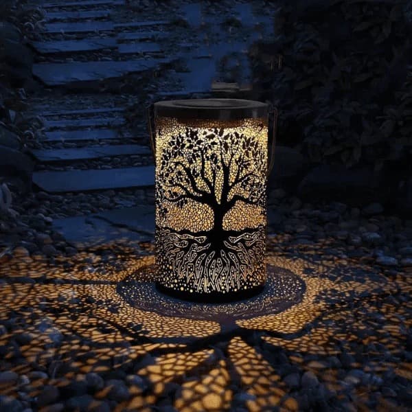 3D solar tree of life lantern casting warm amber shadow patterns across a table — view 5