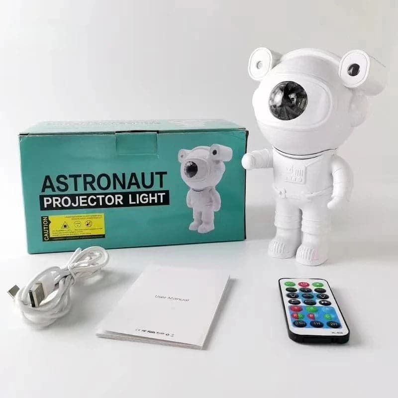 Astronaut-shaped galaxy projector casting stars and nebula across a bedroom ceiling — view 2