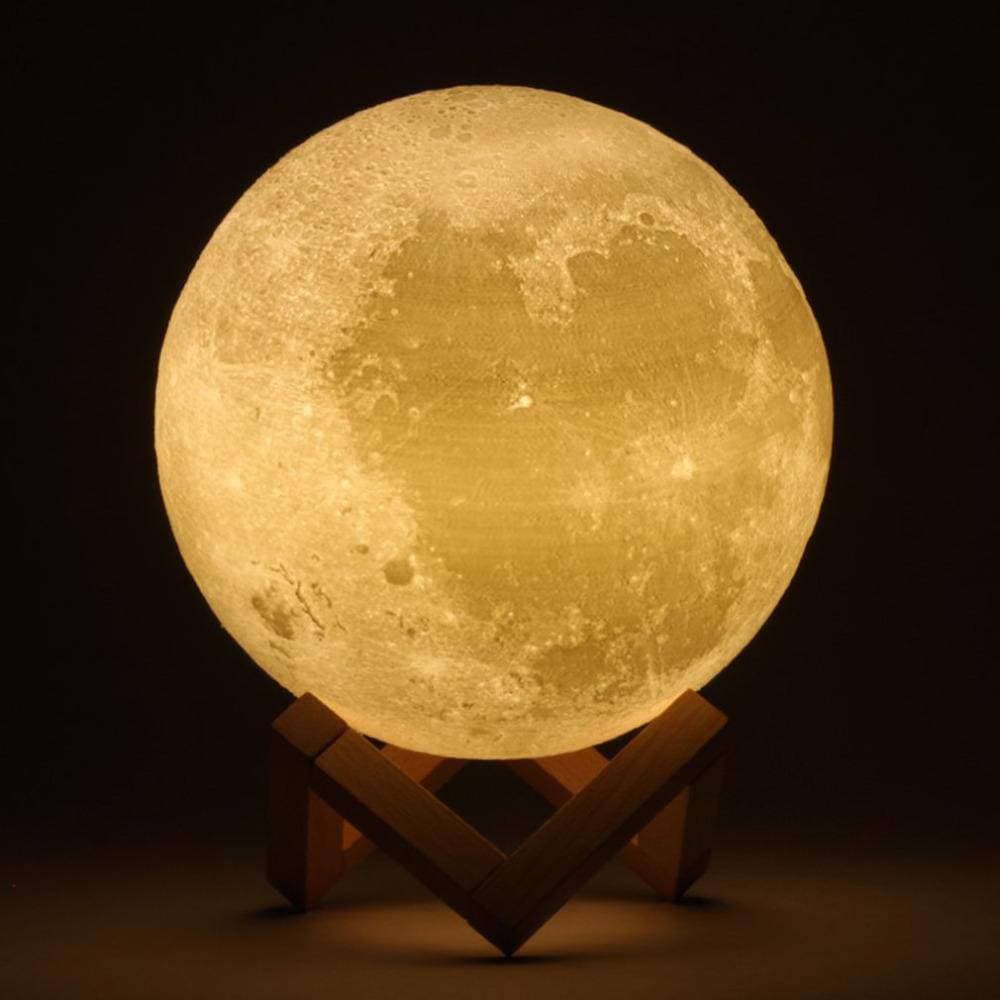 20cm 3D moon lamp glowing soft warm white on a wooden desk — view 2