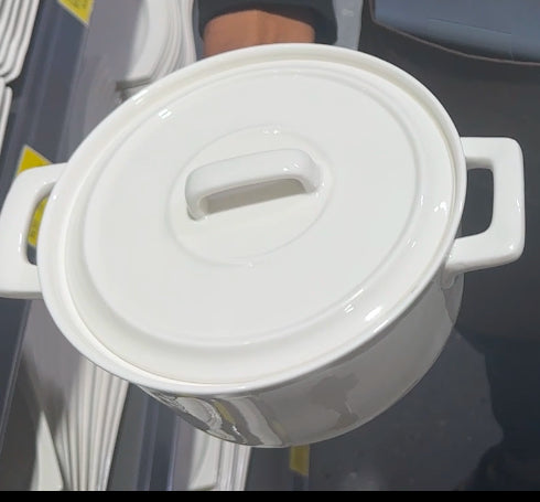 White casserole pot with handle-style lid  ceramic cookware for serving and baking.