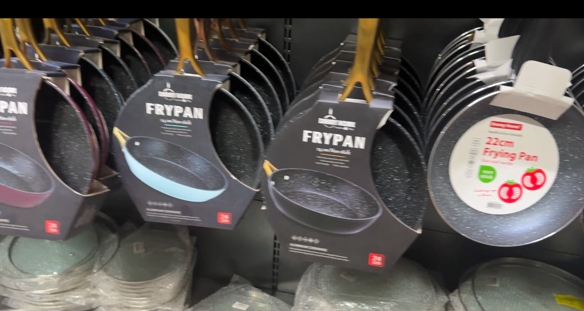 Non-stick granite frying pans with marble coating in assorted colors displayed on store shelf