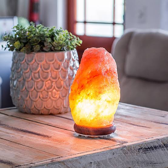 Natural Himalayan salt lamp glowing orange, hand-carved crystal décor for relaxation and air purification from Ze Home Finds.
