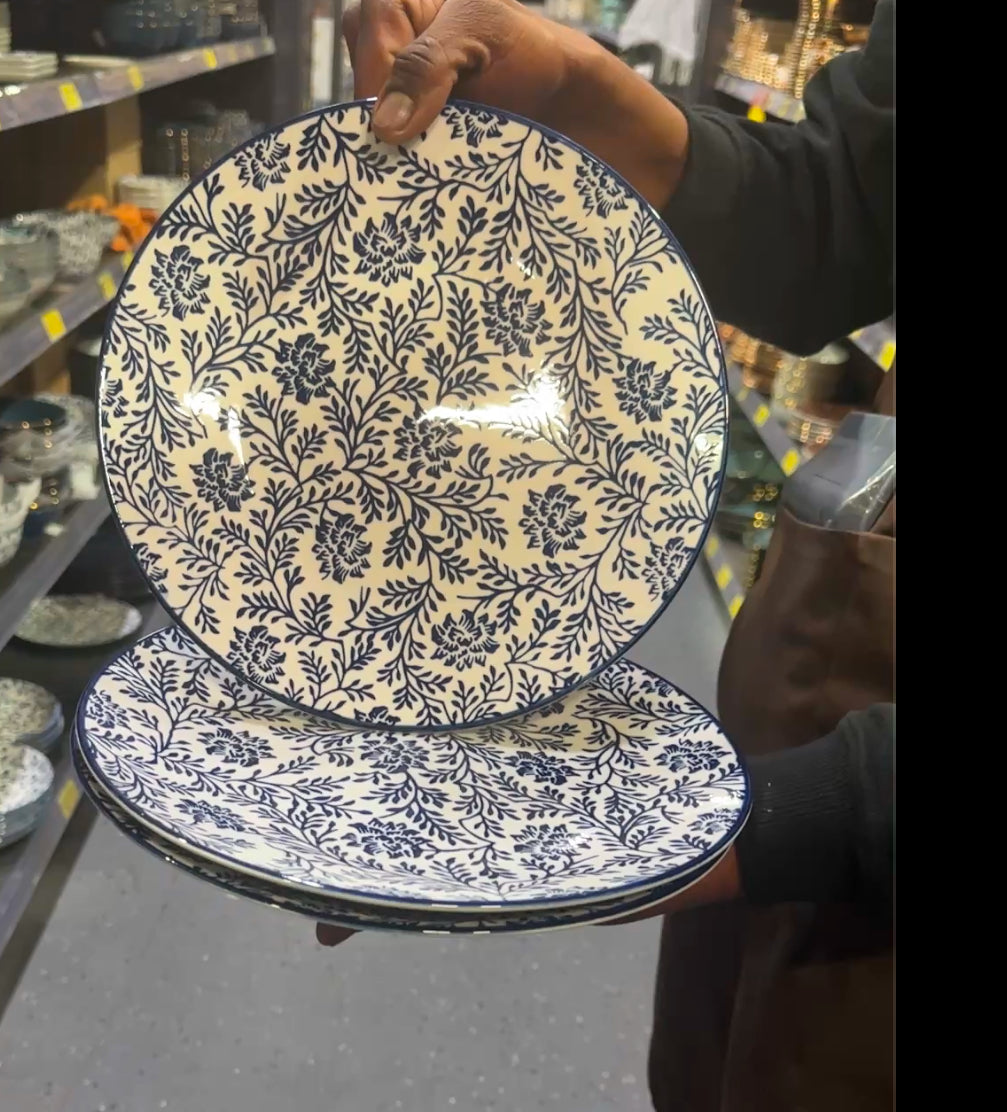 Blue Meadow navy floral ceramic salad plate held by hand – ideal for serving salads or desserts.