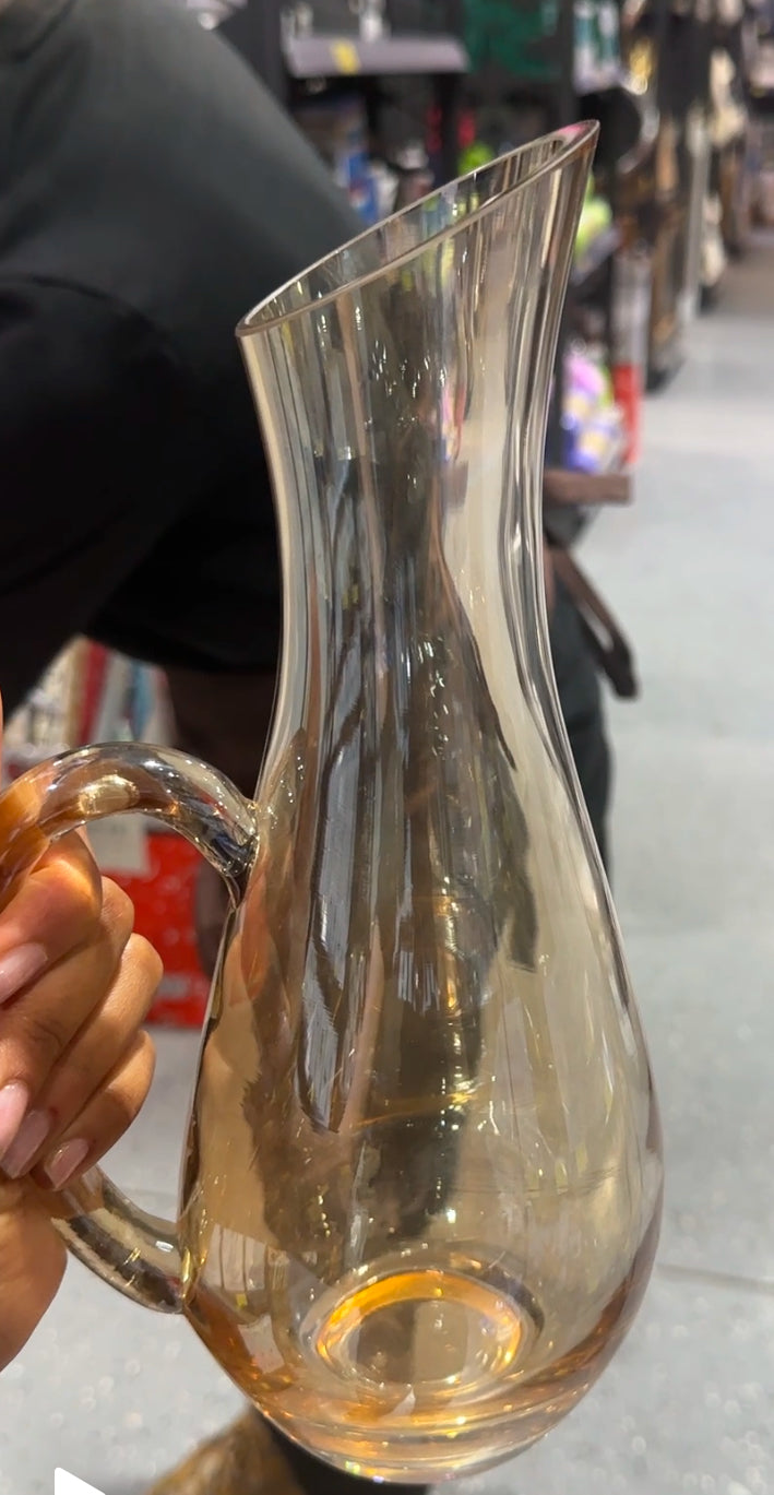 Elegant gold handle glass wine vase used as a wine decanter and decorative centerpiece for modern home decor.