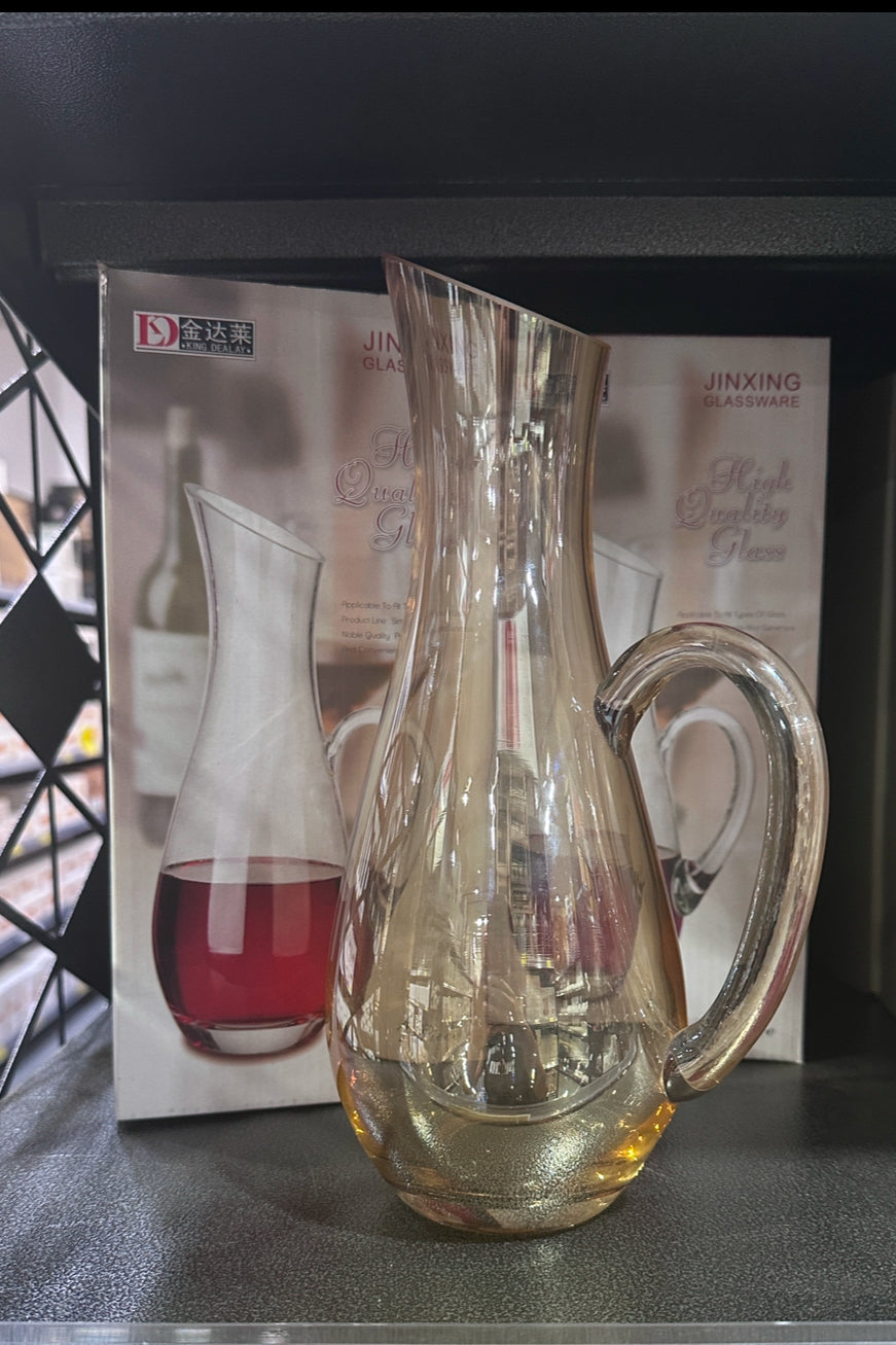 Elegant gold handle glass wine vase used as a wine decanter and decorative centerpiece for modern home decor.