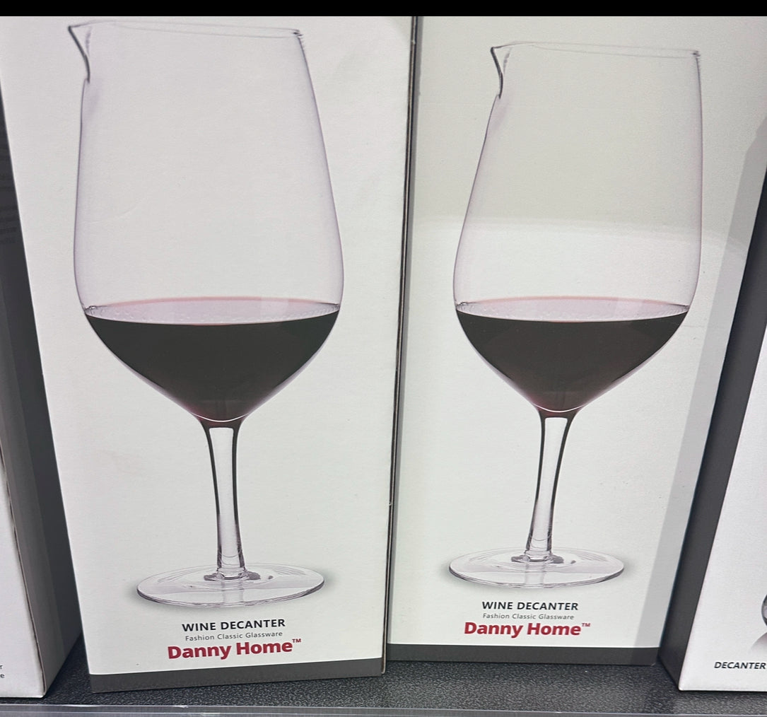 Tall clear glass wine decanter with flared lip and stem – stylish wine aerator and display piece 
