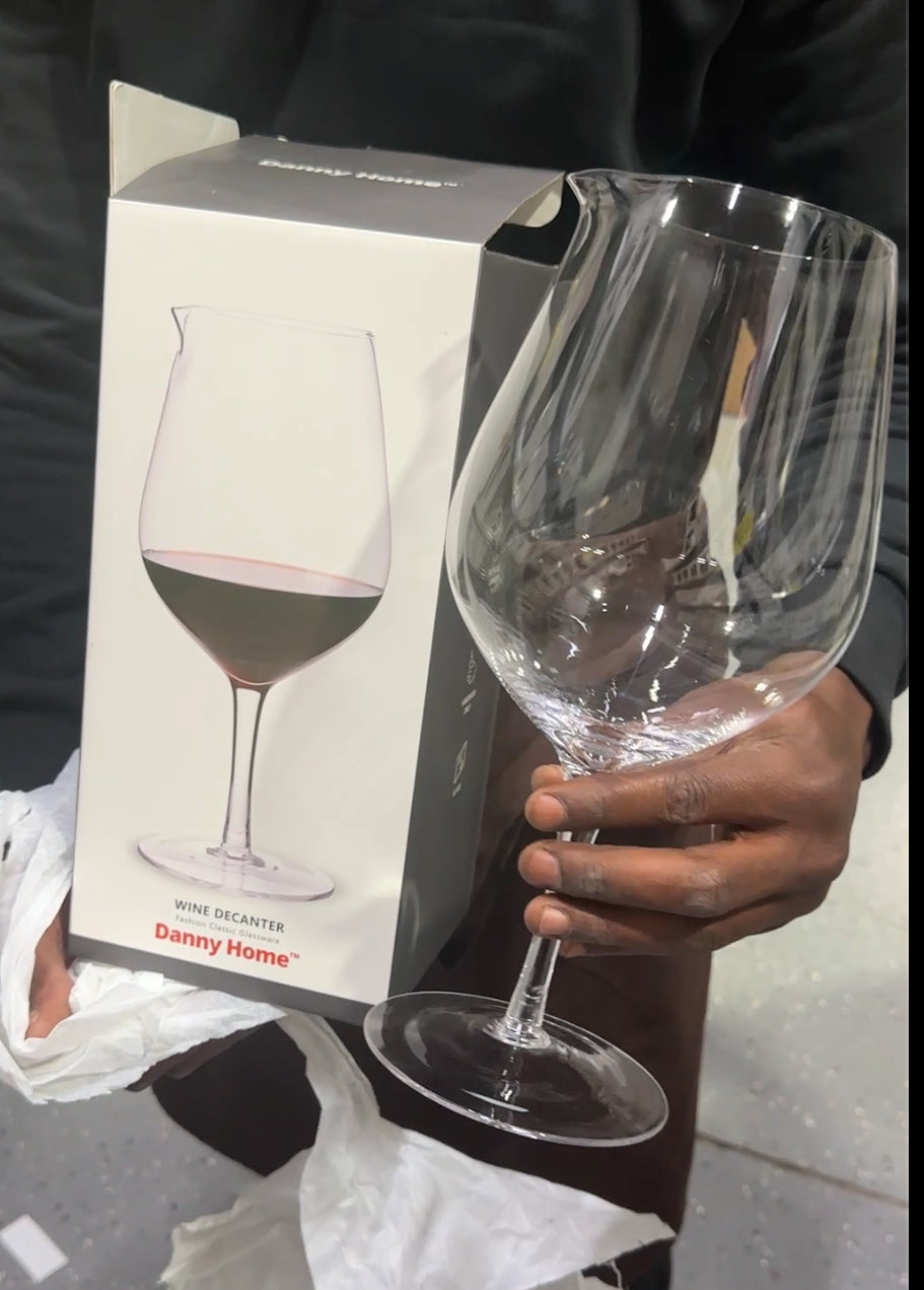 Tall clear glass wine decanter with flared lip and stem – stylish wine aerator and display piece 
