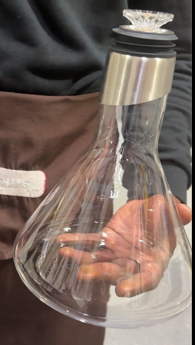 Elegant glass wine decanter with diamond-cut crystal stopper and stainless steel neck – premium wine serving carafe 
